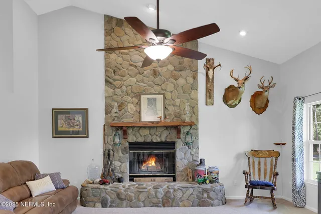 a living room with furniture and a ceiling fan
