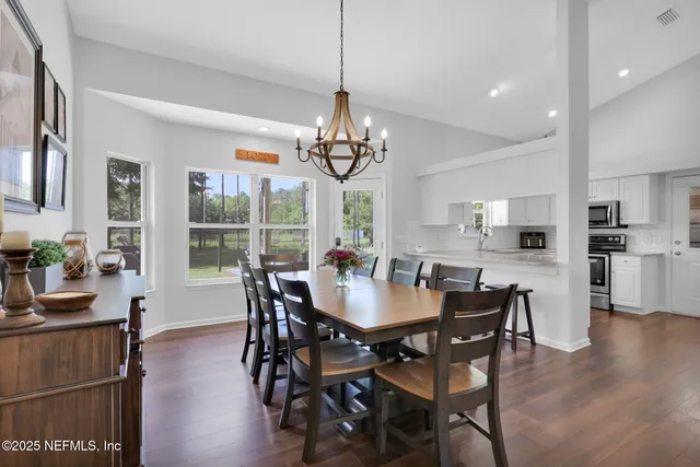 a kitchen with stainless steel appliances granite countertop a sink a stove and cabinets