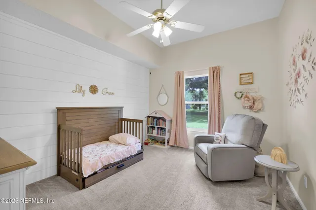a bedroom with a bed and furniture with outer view