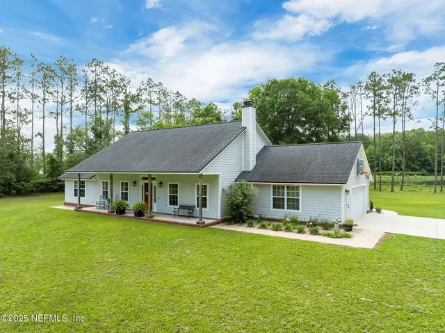 a front view of a house with a yard table and chairs