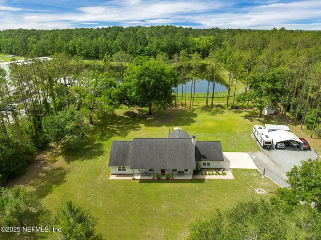a front view of house with yard and green space