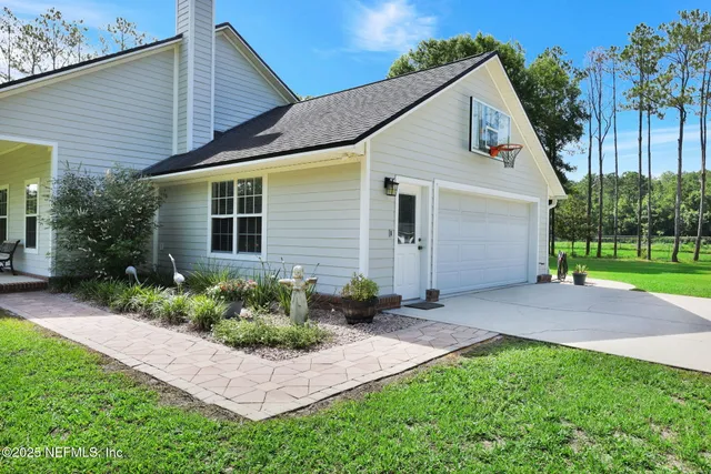 a front view of a house with a yard and patio