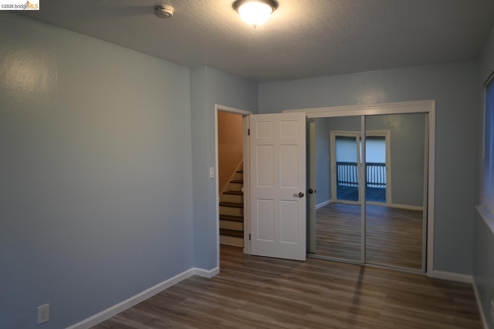 1316 Russell Street Berkeley, CA 94702 - Photo 14 of 23 an empty room with wooden floor and closet
