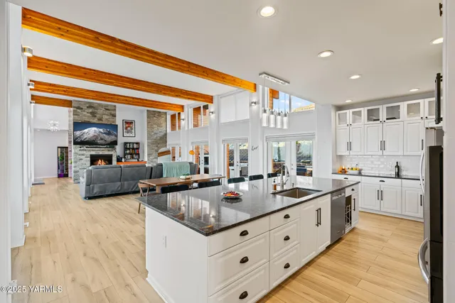 a kitchen with stainless steel appliances granite countertop a sink and dishwasher with wooden floor