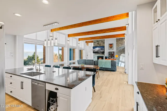 a kitchen with sink and view of living room