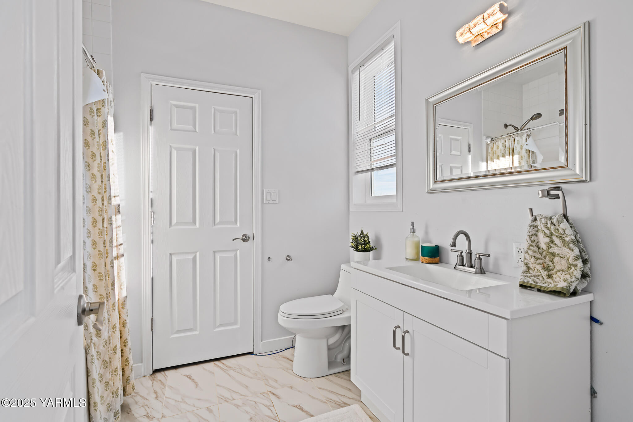 925 Goodlander Circle Selah, WA 98942 - Photo 21 of 43 a bathroom with a granite countertop toilet a sink and a mirror