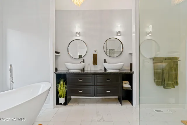 a bathroom with a tub sink and mirror