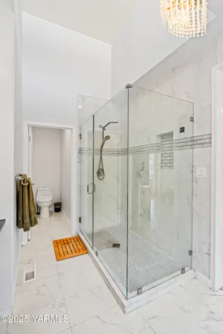 a bathroom with a shower and a sink