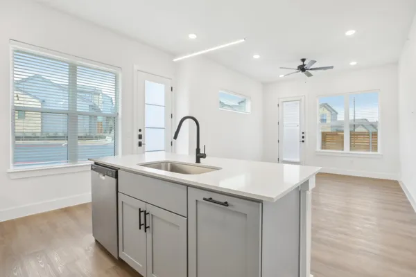 a kitchen with a sink and chandelier