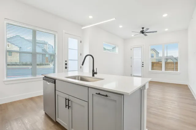 a kitchen with a sink and chandelier