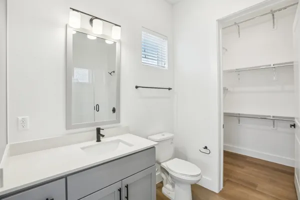 a bathroom with a sink a toilet and a mirror