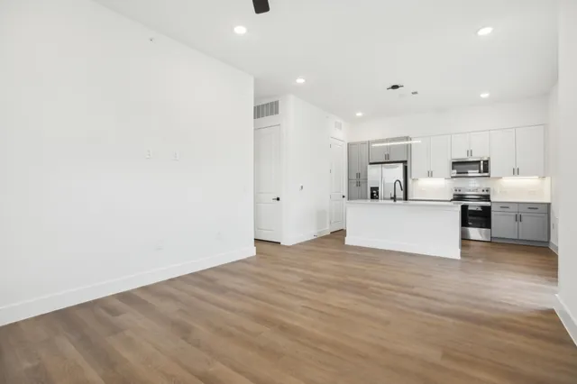 a view of a kitchen with wooden floor