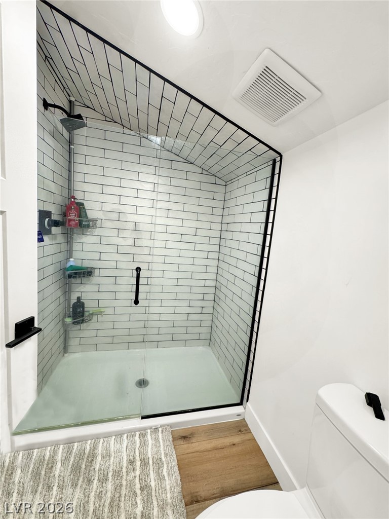9393 North 93rd Highway Caliente, NV 89008 - Photo 13 of 41 A chic shower enclosure featuring subway tile and a sleek glass door, creating a clean, modern aesthetic.