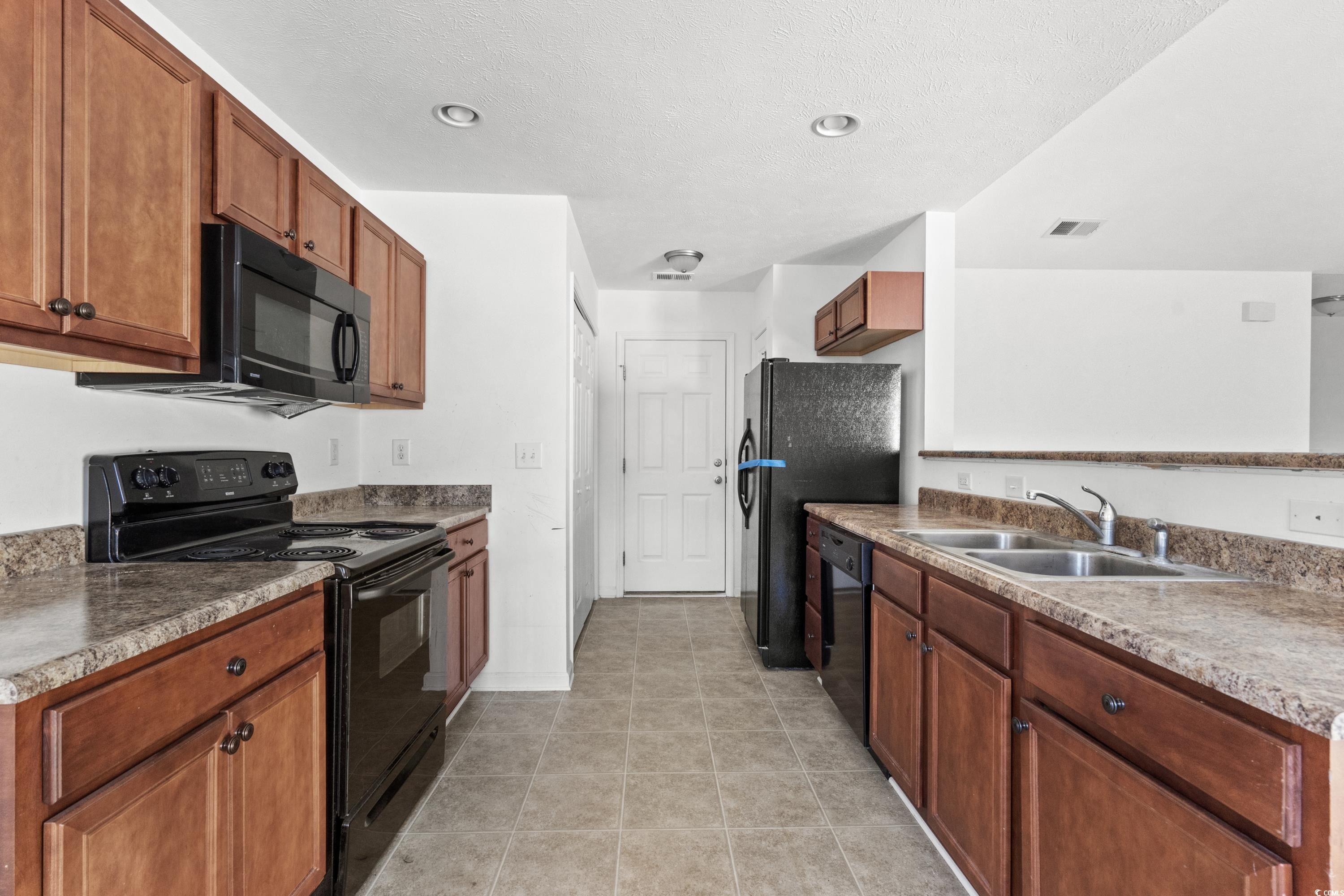 605 West Perry Road Myrtle Beach, SC 29579 - Photo 13 of 36 Kitchen featuring light tile patterned floors, sin