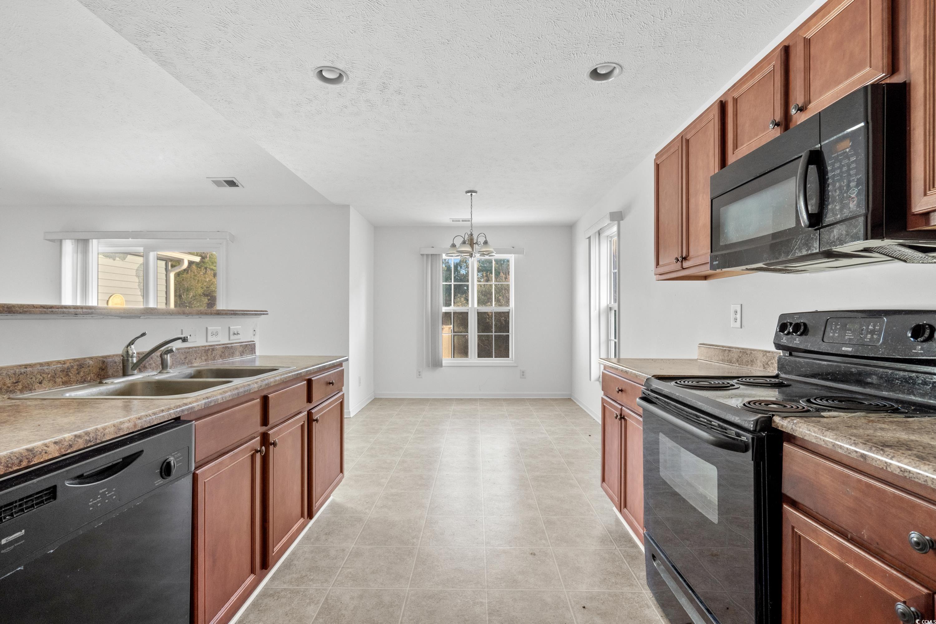 605 West Perry Road Myrtle Beach, SC 29579 - Photo 14 of 36 Kitchen featuring a textured ceiling, a chandelier
