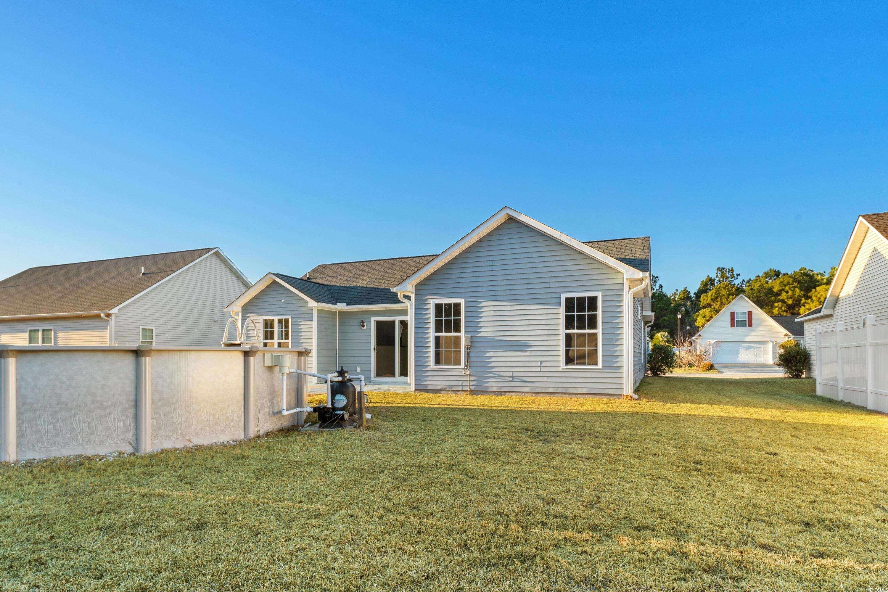 605 West Perry Road Myrtle Beach, SC 29579 - Photo 20 of 36 Rear view of property featuring a yard