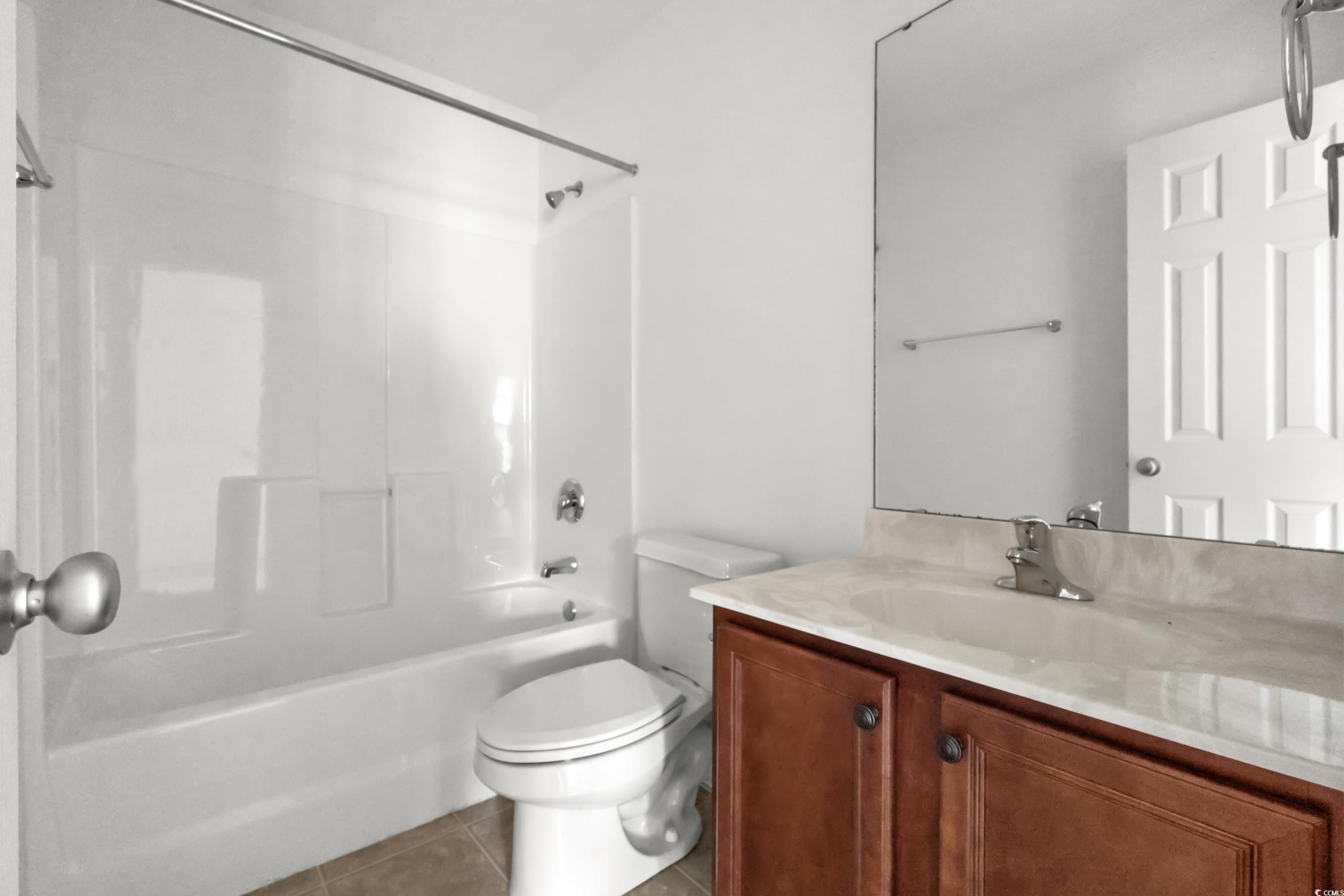605 West Perry Road Myrtle Beach, SC 29579 - Photo 29 of 36 Full bathroom with toilet, vanity, tile patterned