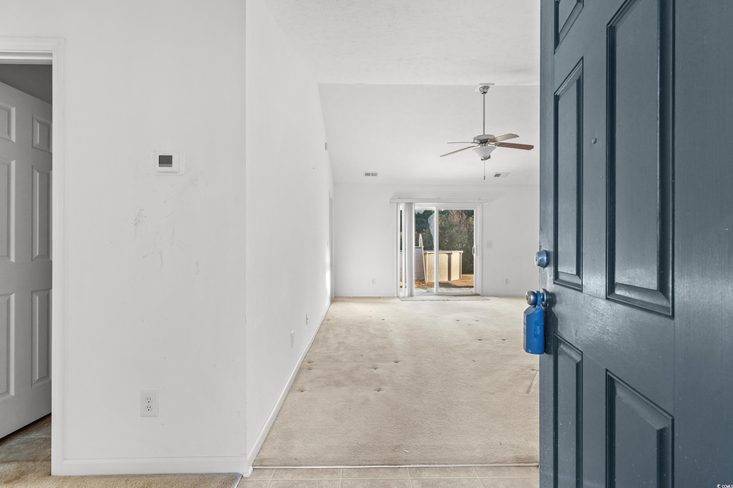 605 West Perry Road Myrtle Beach, SC 29579 - Photo 3 of 36 Carpeted entryway with ceiling fan