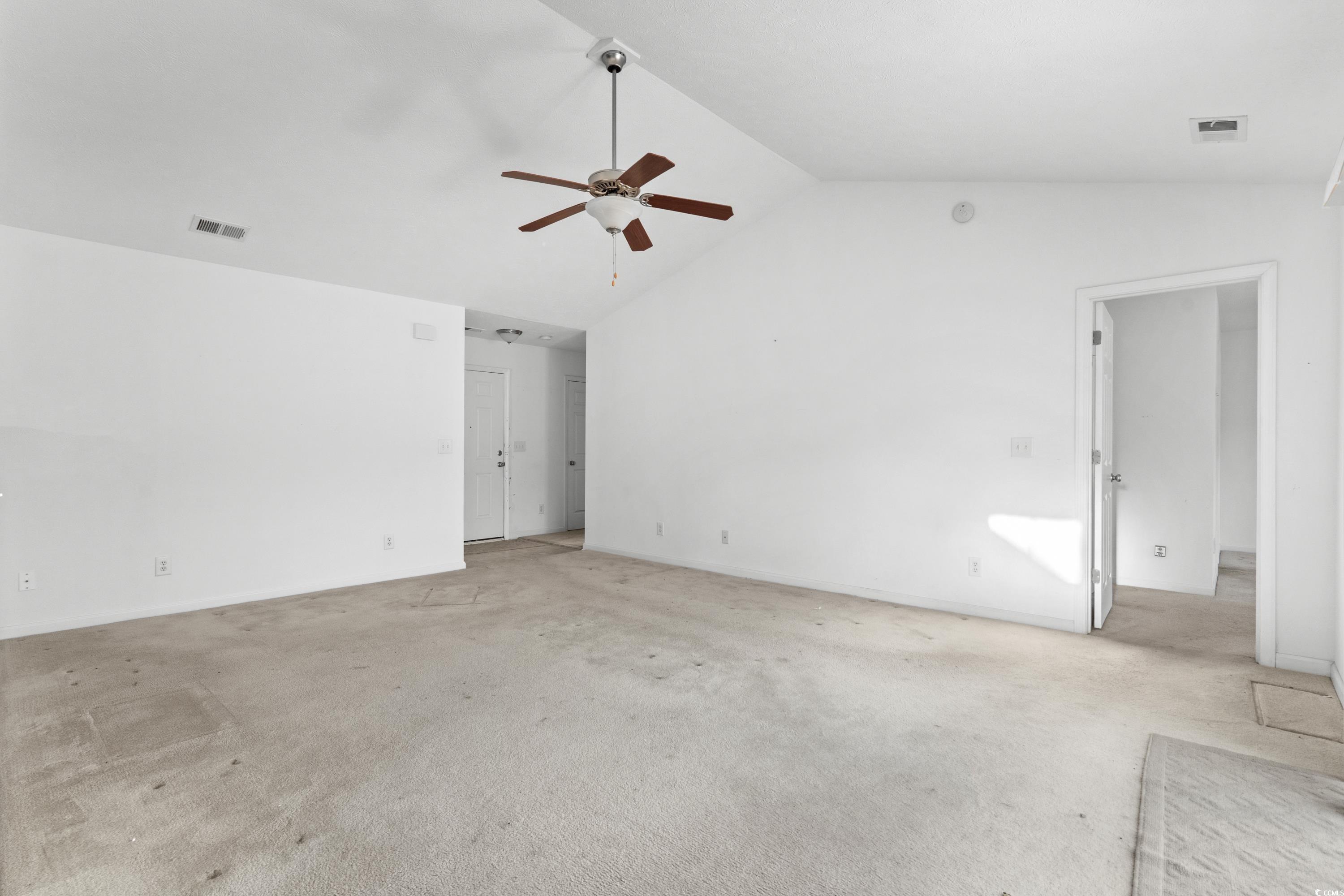 605 West Perry Road Myrtle Beach, SC 29579 - Photo 6 of 36 Empty room with light carpet, ceiling fan, and lof