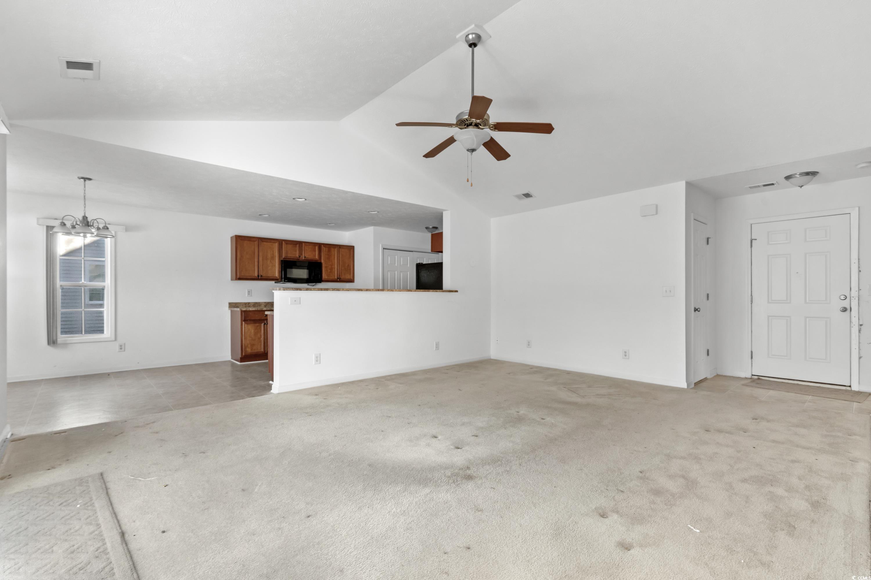 605 West Perry Road Myrtle Beach, SC 29579 - Photo 7 of 36 Unfurnished living room with vaulted ceiling, ligh