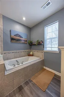 a view of walk in closet with clothes