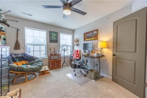 a living room with furniture and a potted plant