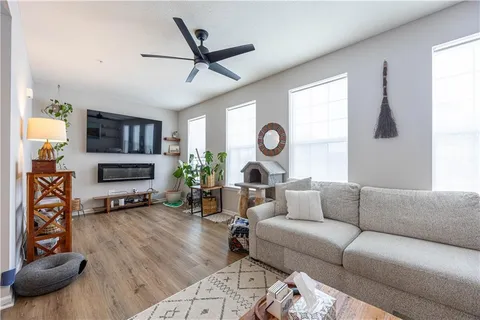 a living room with furniture a window and a flat screen tv