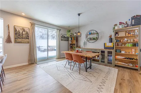 a living room with furniture a window and a clock