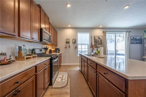 a kitchen with stainless steel appliances granite countertop lots of counter top space and cabinets