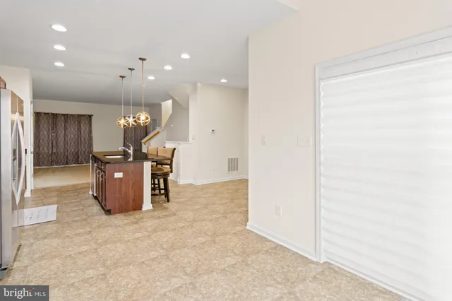 a kitchen with a refrigerator and a sink