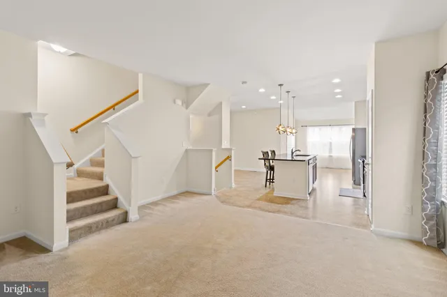 a view of a living room and kitchen with furniture