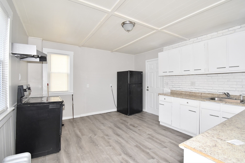 51-53 Eloise Street Springfield, MA 01118 - Photo 18 of 20 a kitchen with granite countertop a refrigerator and a sink