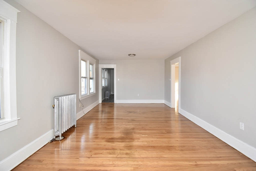 51-53 Eloise Street Springfield, MA 01118 - Photo 4 of 20 a view of an empty room with wooden floor