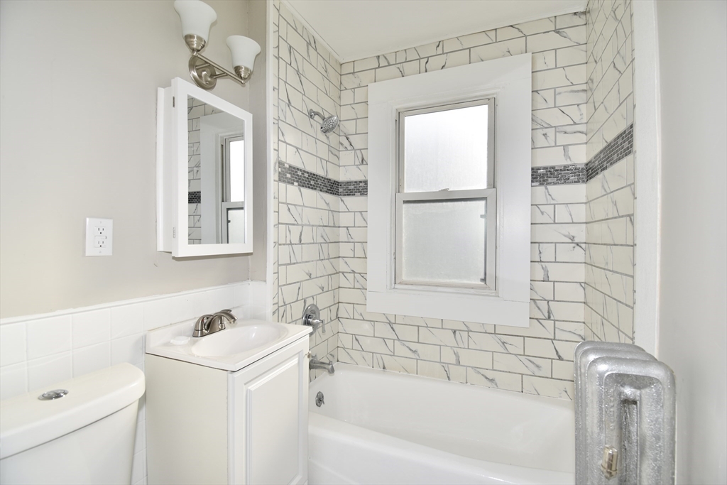 51-53 Eloise Street Springfield, MA 01118 - Photo 6 of 20 a bathroom with a sink a toilet and shower