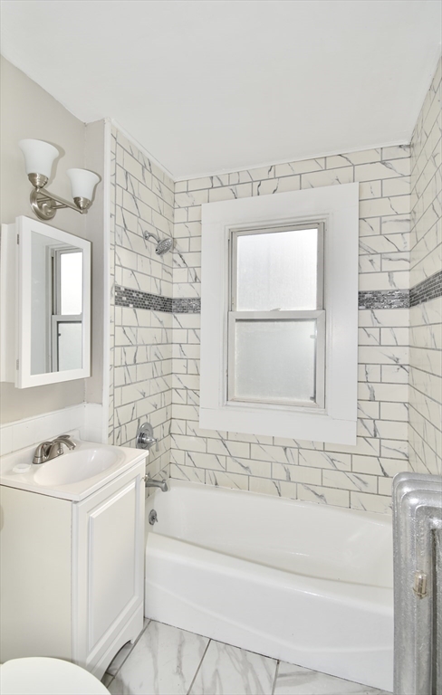 51-53 Eloise Street Springfield, MA 01118 - Photo 7 of 20 a bathroom with a bathtub a sink and a window