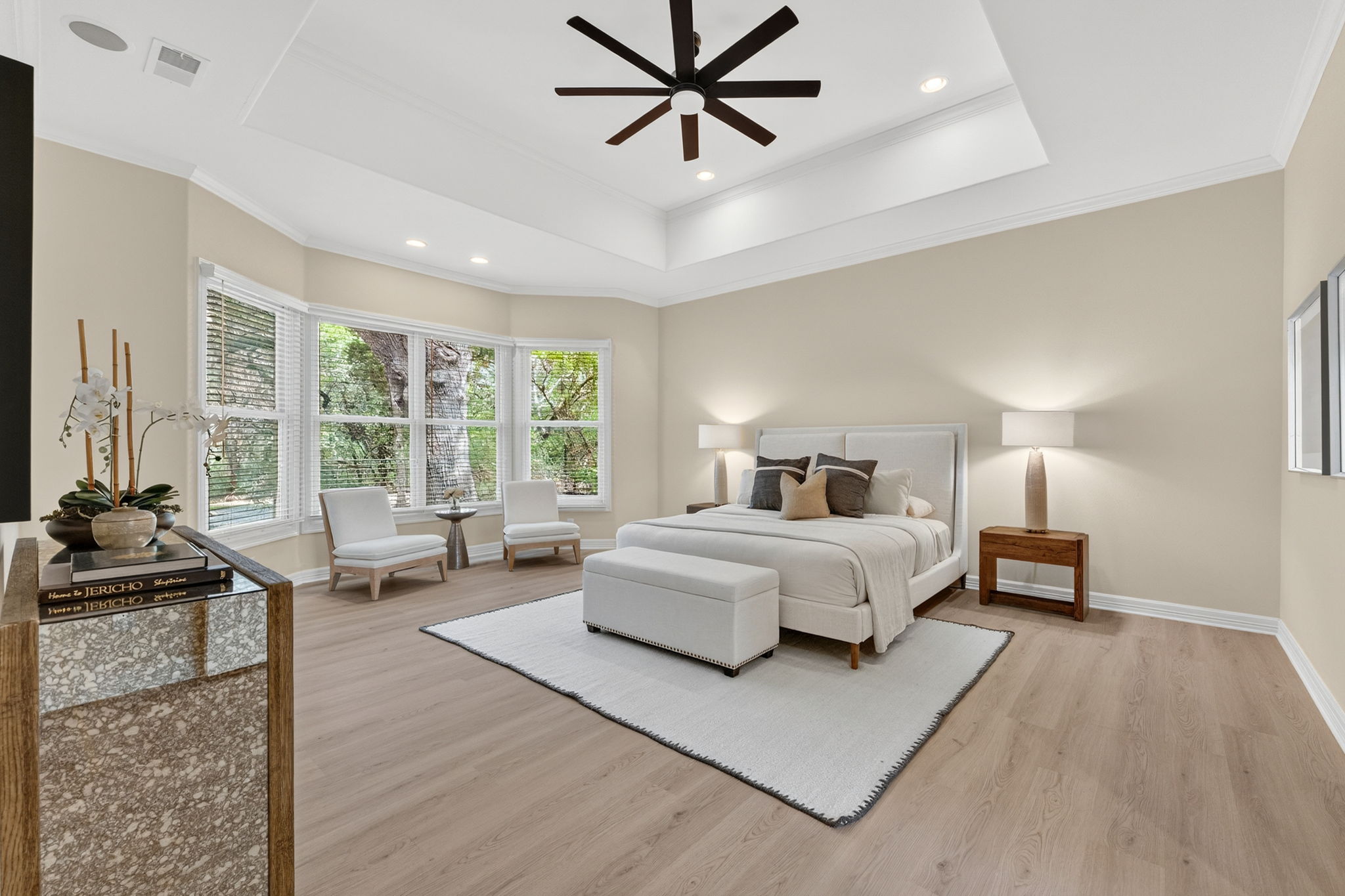 4110 Bunny Run, Unit 3 Austin, TX 78746 - Photo 14 of 35 This spacious room features light wood-style flooring, a tray ceiling with a ceiling fan, and recessed lighting