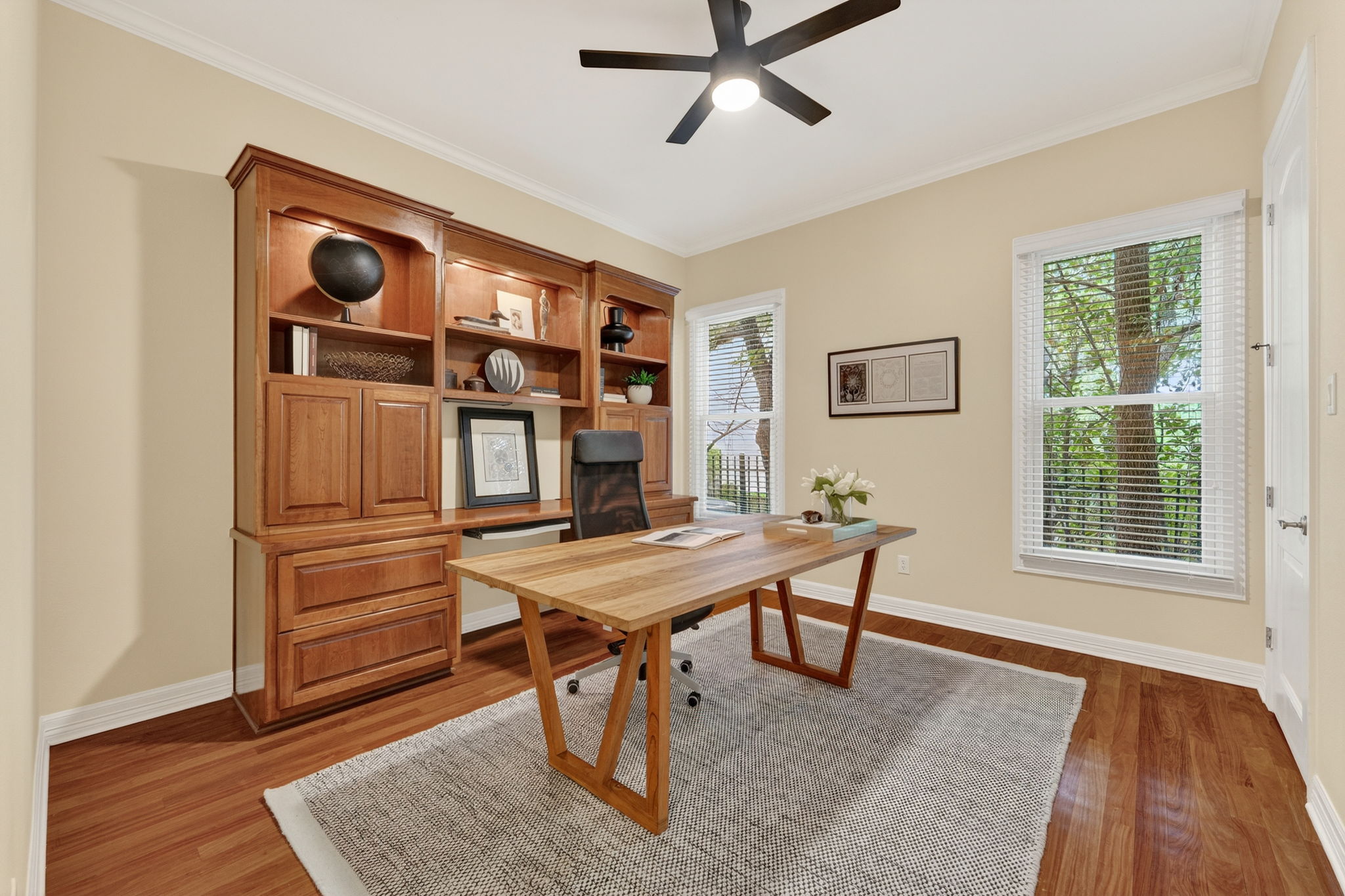 4110 Bunny Run, Unit 3 Austin, TX 78746 - Photo 18 of 35 This room features rich hardwood flooring, a built-in wooden shelving unit, and two windows providing ample natural light