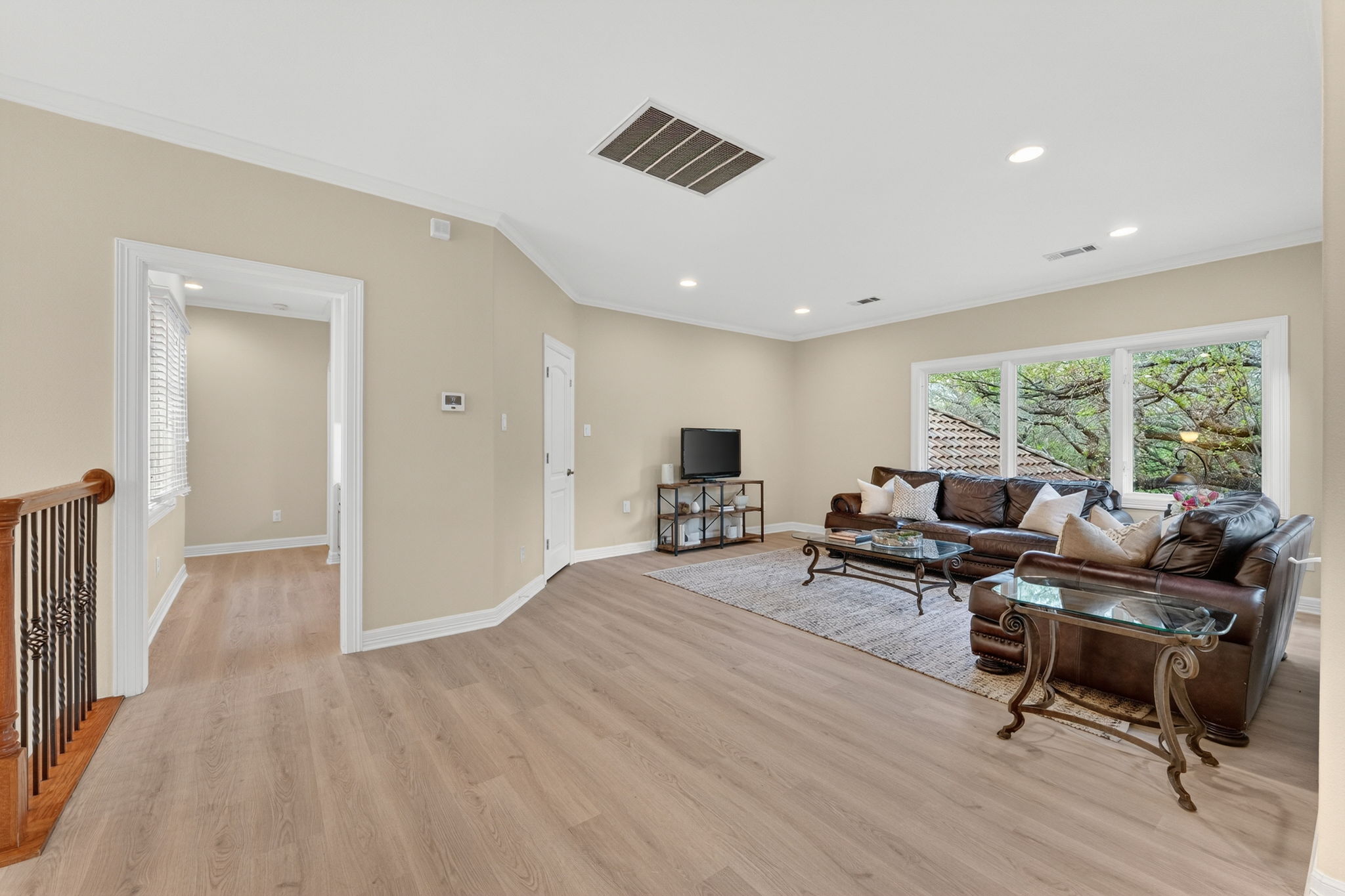 4110 Bunny Run, Unit 3 Austin, TX 78746 - Photo 20 of 35 Spacious room featuring light-colored flooring, recessed lighting, and large windows