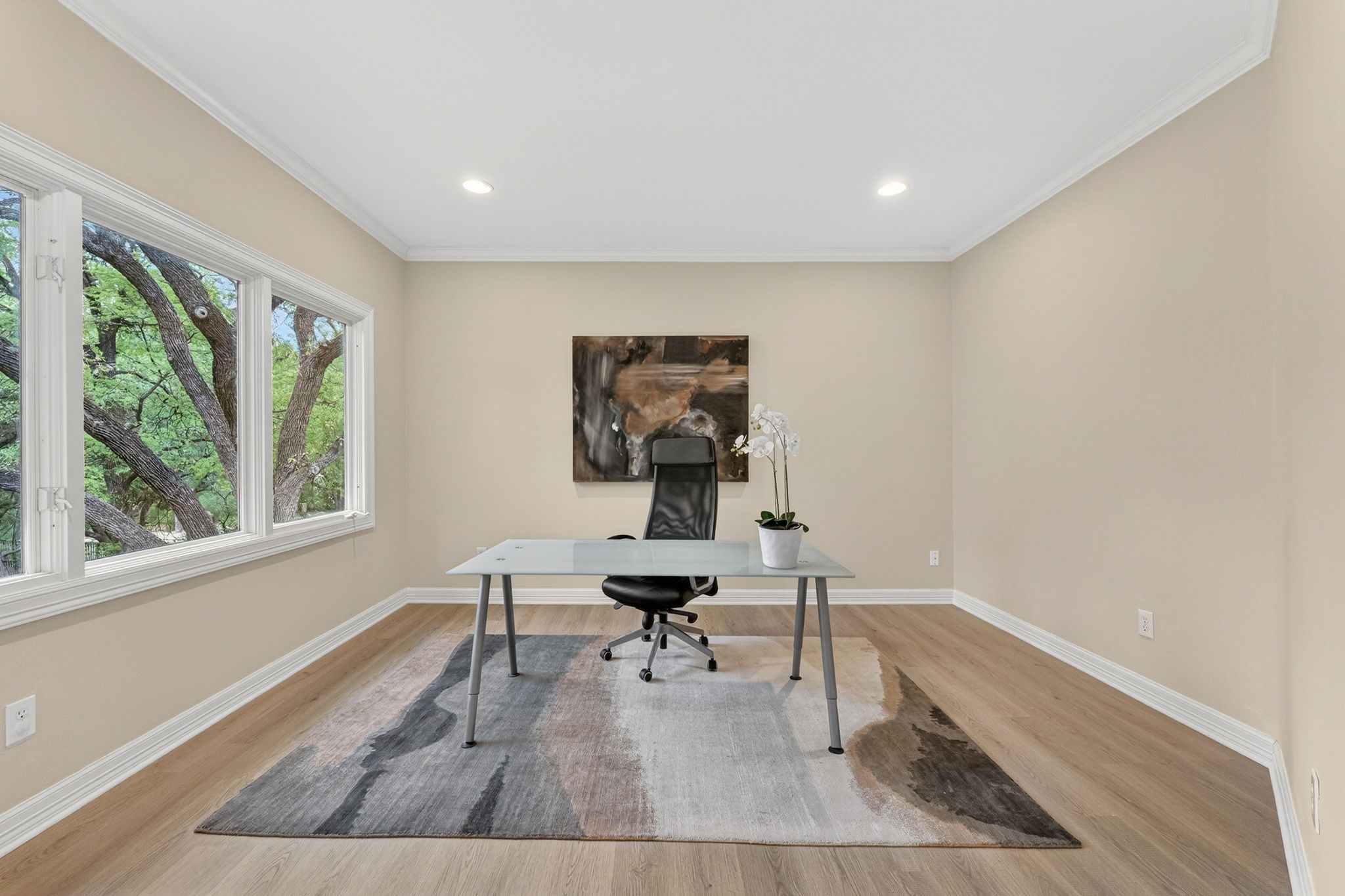 4110 Bunny Run, Unit 3 Austin, TX 78746 - Photo 22 of 35 This room features light wood flooring, recessed lighting, and large windows with views of surrounding trees