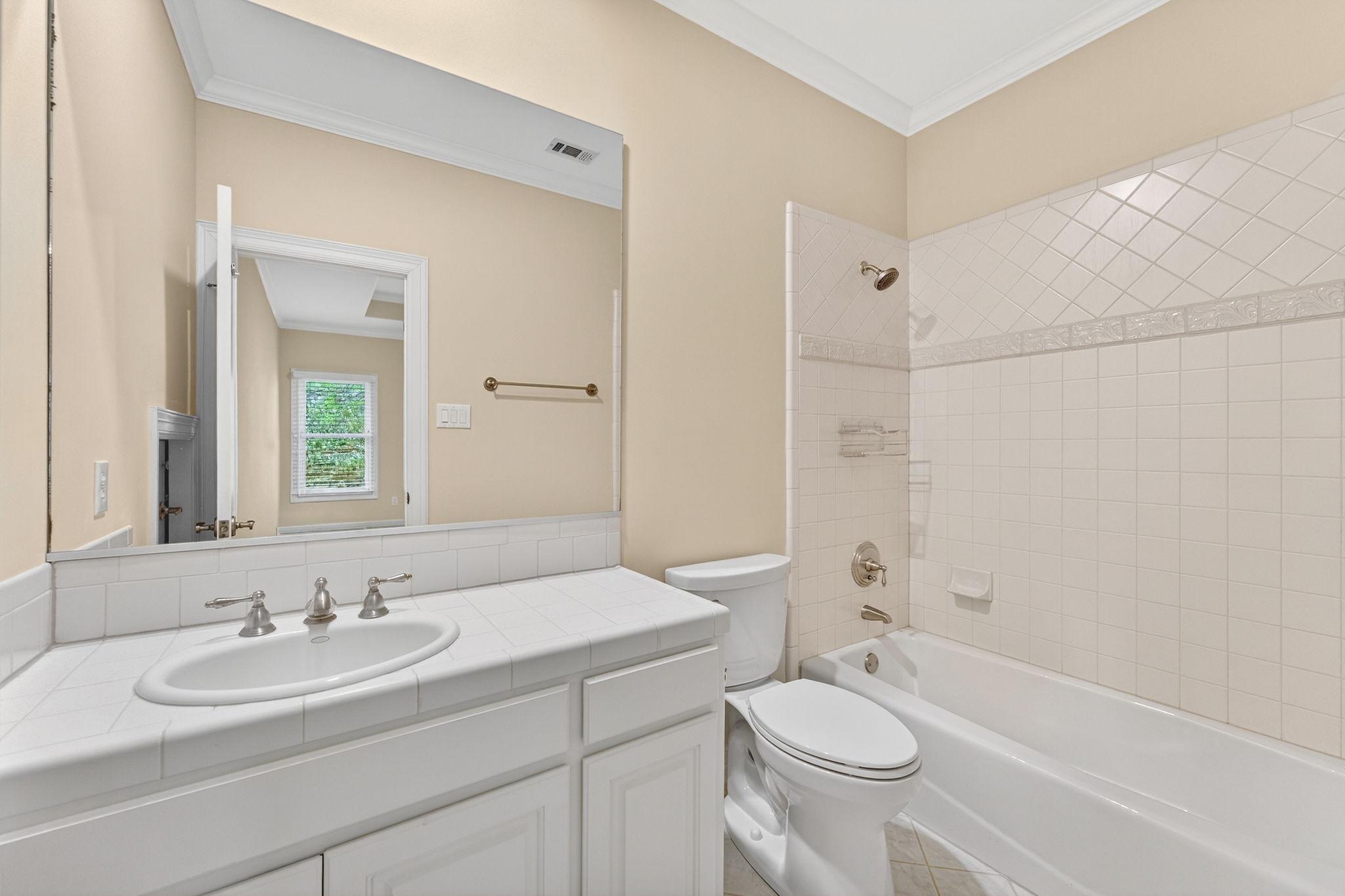 4110 Bunny Run, Unit 3 Austin, TX 78746 - Photo 28 of 35 Bathroom featuring a vanity with a white tile countertop, a white drop-in sink with a brushed nickel faucet, and a toilet