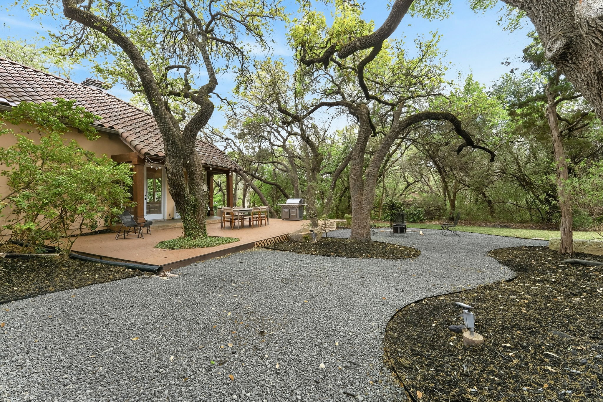 4110 Bunny Run, Unit 3 Austin, TX 78746 - Photo 31 of 35 The property features a terracotta tiled roof and a spacious outdoor deck
