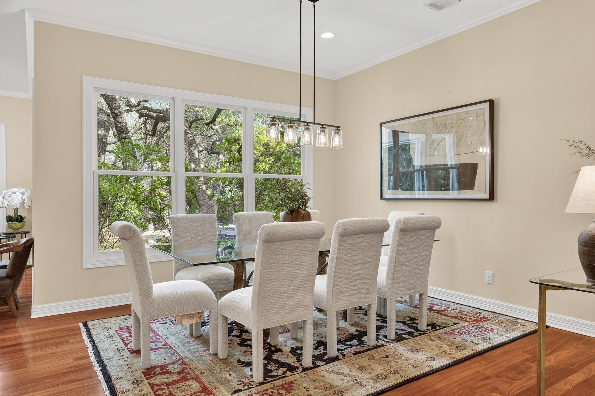 4110 Bunny Run, Unit 3 Austin, TX 78746 - Photo 6 of 35 This dining area features hardwood floors and a large window with a view of mature trees