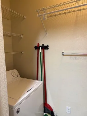 a view of walk in closet with empty racks