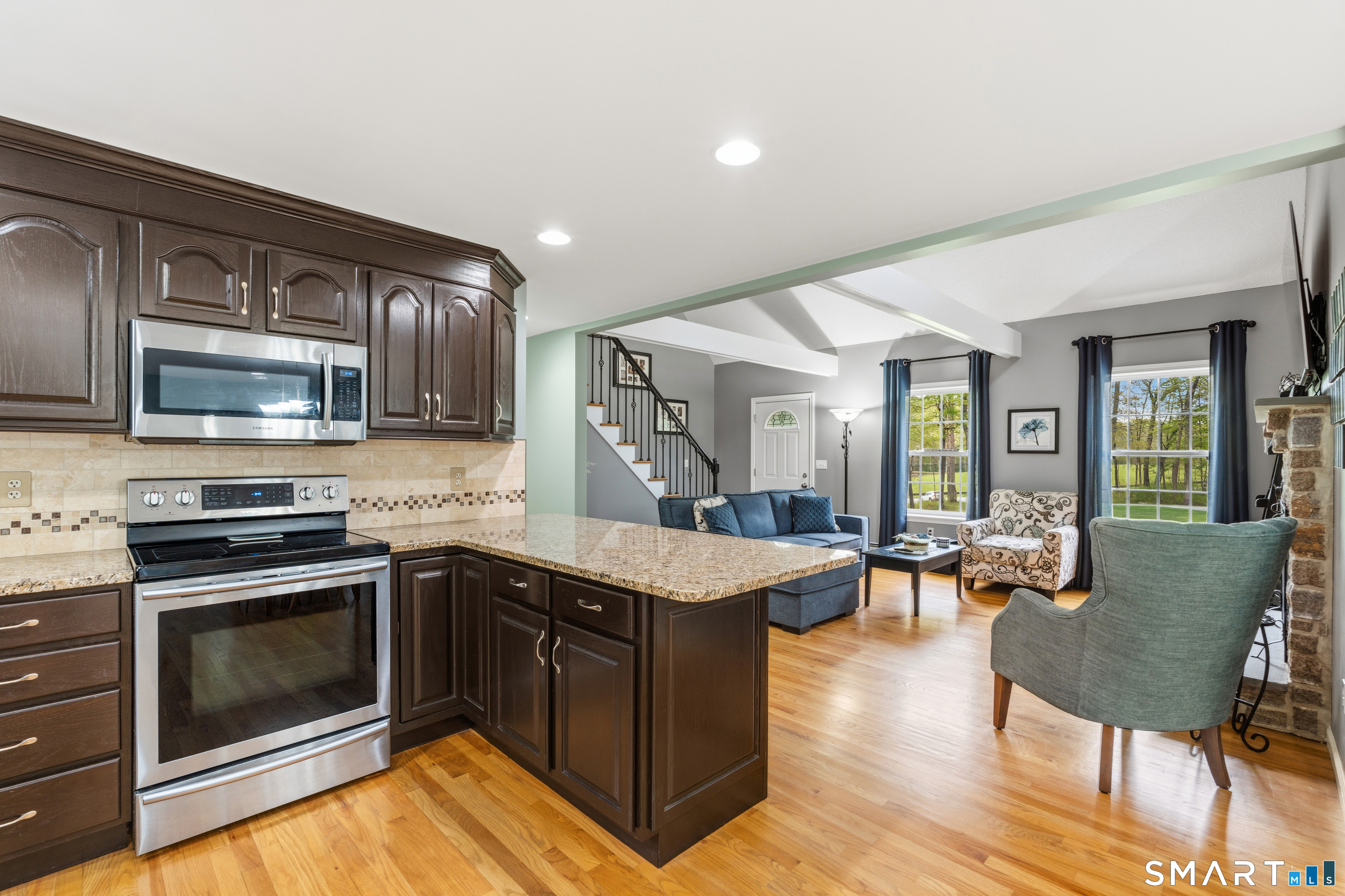 362 Turnpike Road Ashford, CT 06278 - Photo 17 of 40 a kitchen with stainless steel appliances granite countertop a stove top oven a sink dishwasher a dining table and chairs with wooden floor