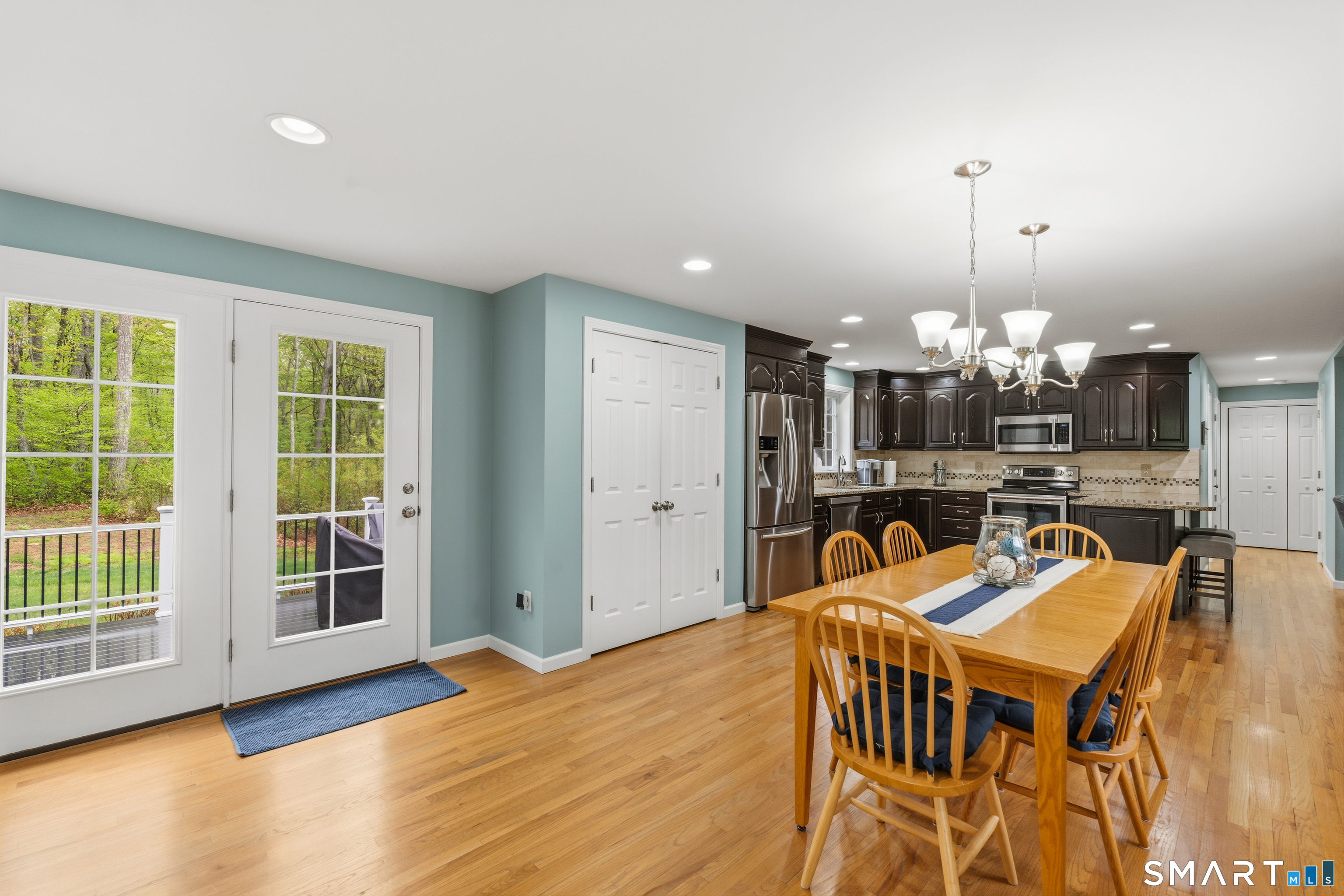362 Turnpike Road Ashford, CT 06278 - Photo 19 of 40 a dining room with furniture a chandelier and wooden floor