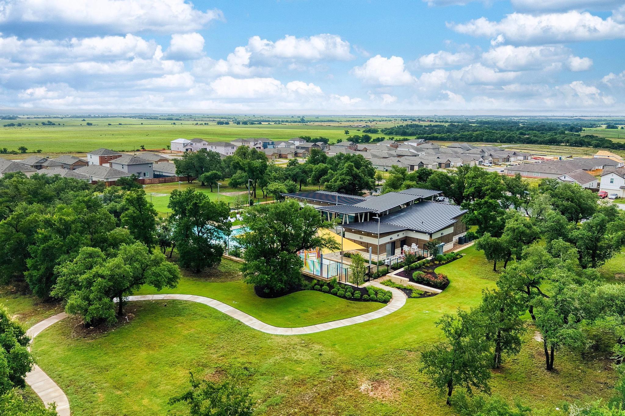 217 Innisfree Road Jarrell, TX 76537 - Photo 20 of 21 Discover a vibrant community hub with a contemporary clubhouse, inviting pool, and ample green space.