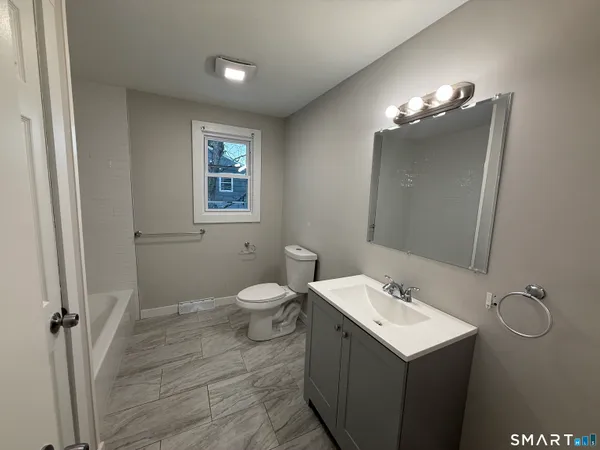 a bathroom with a sink vanity and mirror