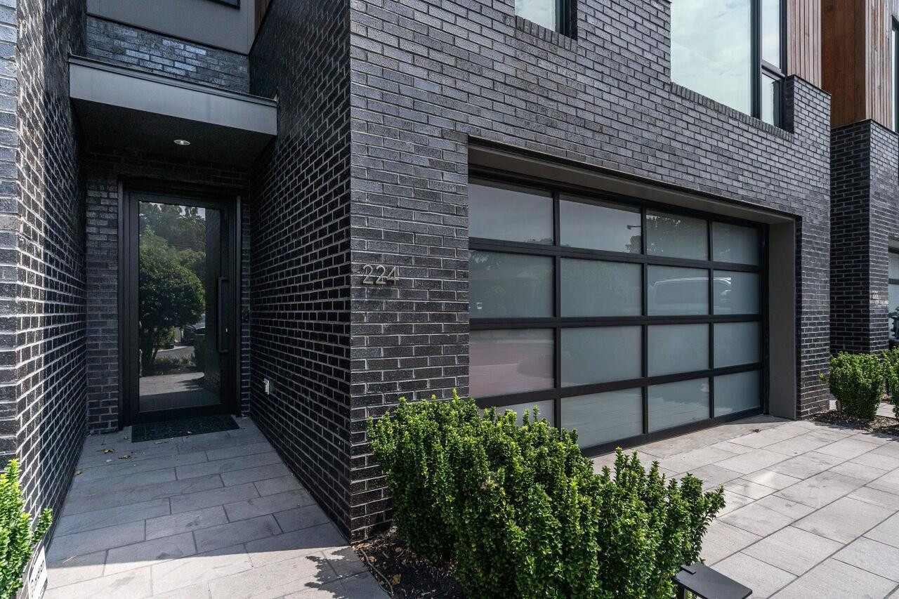 224 Dundas Lane Raleigh, NC 27603 - Photo 6 of 54 Enter from the two-car Garage or from the Basalt-tile sidewalk. Custom Italian Door, commercial-grade glass Garage Doors. Entry