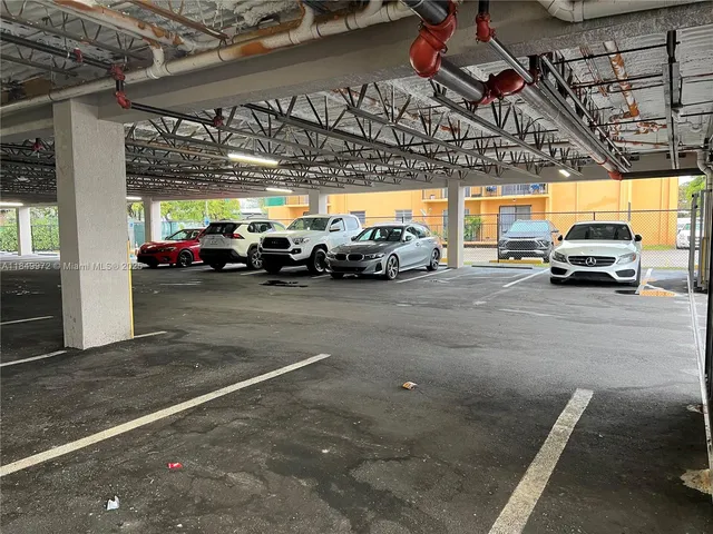 a view of parking garage with cars