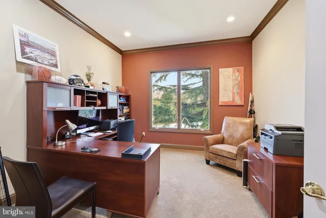 a bedroom with furniture and a large window